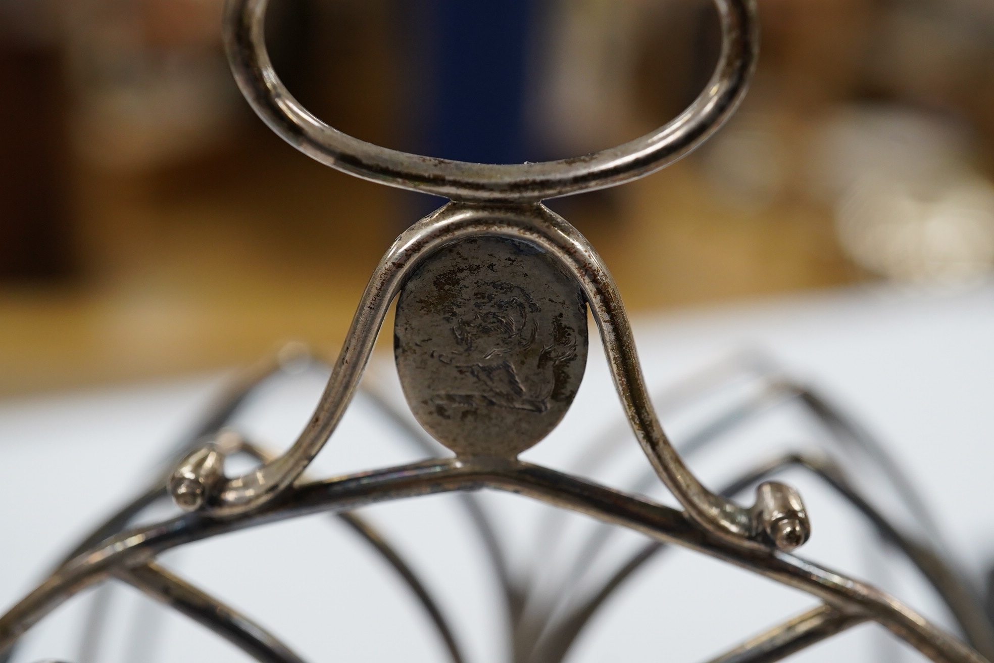 A George III silver seven bar toast rack, by Henry Chawner, London, 1795, with ring handle, length 14.7cm, 5.8oz. Condition - fair